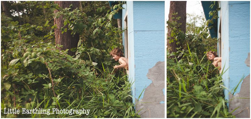 Curly haired boy peeking out of a playhouse